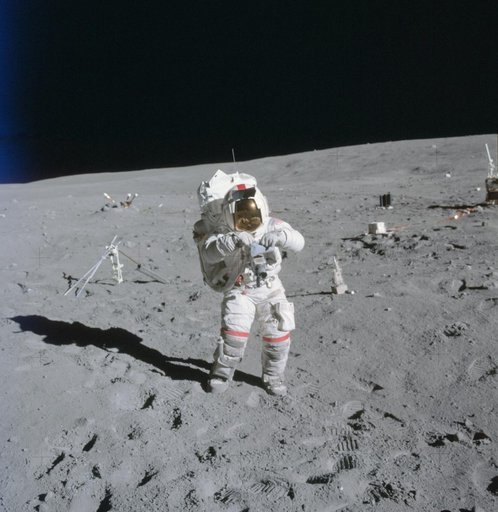 Astronaut John Young stands at ALSEP deployment site during first EVA