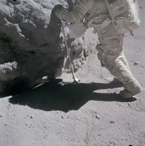 Shadow of astronaut seen in front of rock being sampled