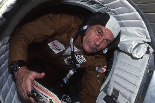 Astronaut Donald Slayton in hatchway between Apollo and Soyuz spacecraft