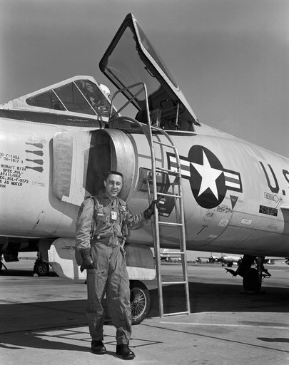 Astronaut Virgil Grissom standing beside F-102 on the flight line