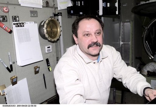 Portrait view of Usachev with checklist in Service Module