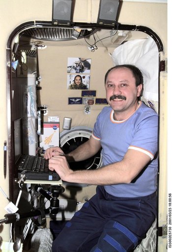 Usachev typing while in sleep station in the Service Module