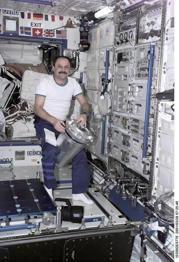 Usachev with water transfer container in Destiny module
