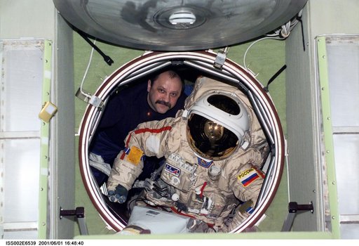 Usachev moves Orlan suit in forward hatch of Zvezda module