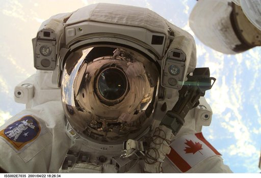 View of STS-100 MS Hadfield during EVA 1 at Destiny laboratory window