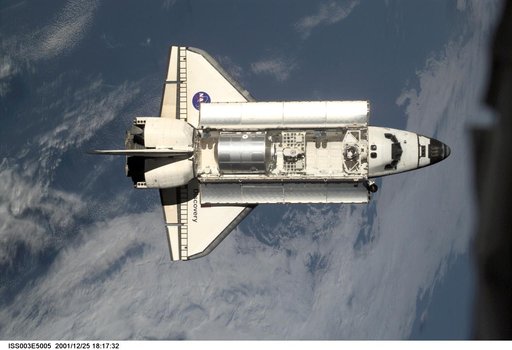 View of Discovery approaching the ISS for docking during the STS-105 mission