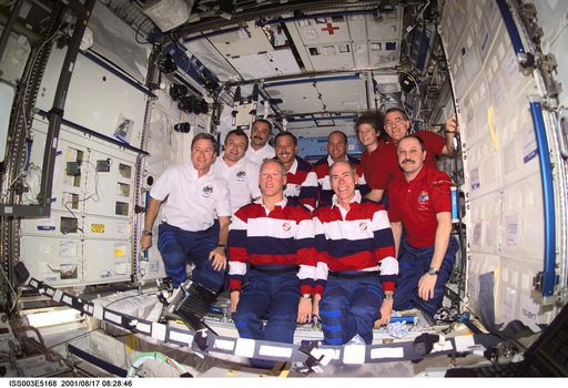 Expedition Three, Expedition Two and STS-105 crews pose in the U.S. Laboratory