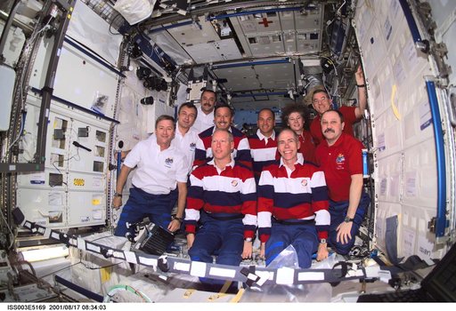 Expedition Three, Expedition Two and STS-105 crews pose in the U.S. Laboratory