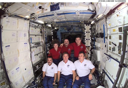 Expedition Three and Expedition Two crews pose in the U.S. Laboratory