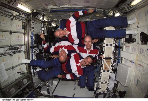 STS-105 crewmembers pose for their group photo in the U.S. Laboratory
