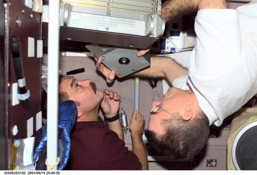 Tyurin and Voss perform maintenance on the TVIS treadmill in the Service Module