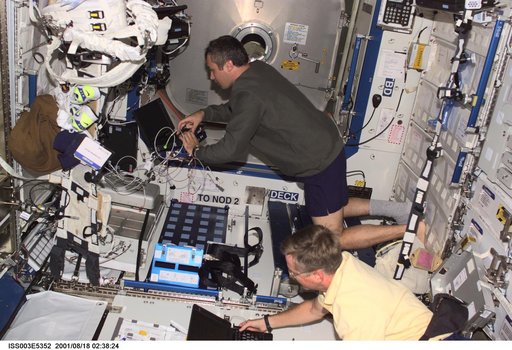 Dezhurov and Culbertson work on laptops in the U.S. Laboratory during Expedition Three