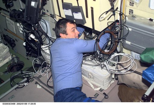 Dezhurov works with electronic equipment in Zvezda during Expedition Three