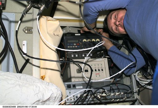 Dezhurov works with electronic equipment in Zvezda during Expedition Three