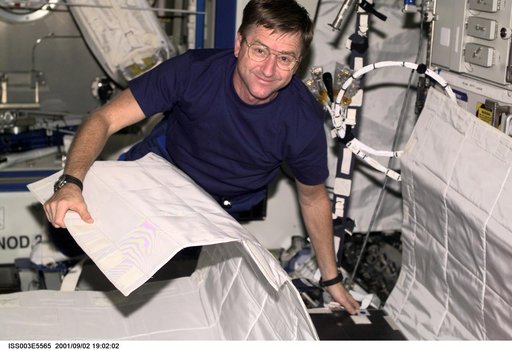 Culbertson sets up the Temporary Sleep Station (TESS) in Destiny during Expedition Three