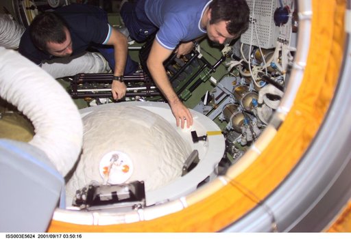 Dezhurov and Tyurin remove the docking probe in Zvezda during Expedition Three