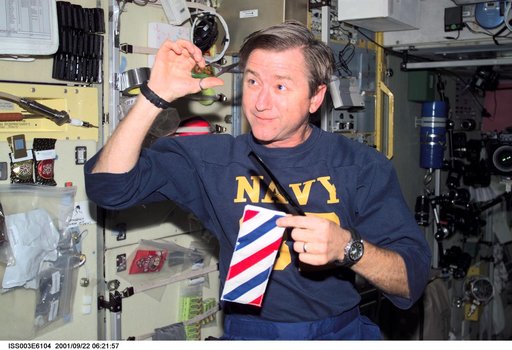 Culbertson cuts his hair in the Service Module during Expedition Three