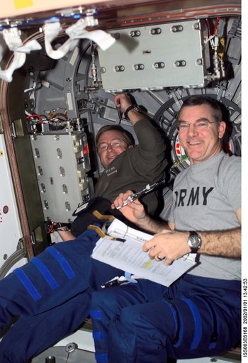 Culbertson and Voss work at a Node 1 hatch during Expedition Three