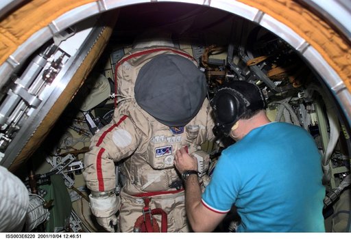 Dezhurov works on an Orlan suit in Pirs during Expedition Three