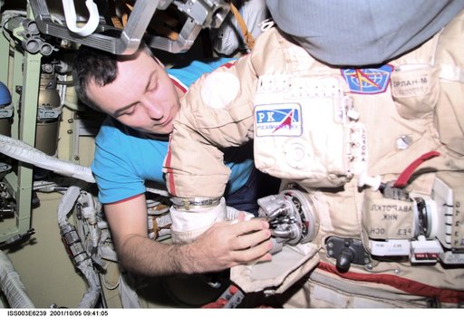 Dezhurov works on an Orlan suit in Pirs during Expedition Three