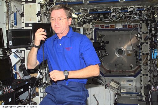 Culbertson talks into a microphone in the U.S. Laboratory during Expedition Three