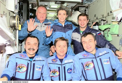 Taxi and Expedition Three crews pose for a group photo in Zvezda during Expedition Three
