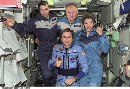 Taxi and Expedition Three crews pose for a group photo in Zvezda during Expedition Three