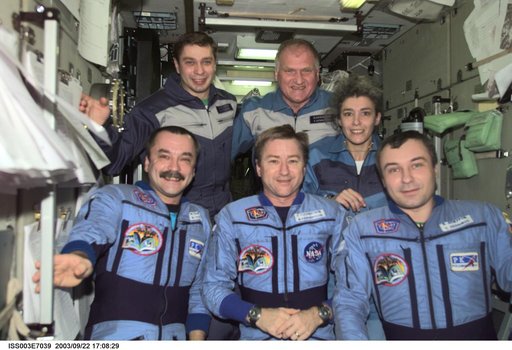 Taxi and Expedition Three crews pose for a group photo in Zvezda during Expedition Three