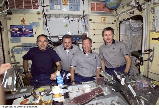 Expedition Three, Expedition Four and STS-108 crews eat a meal in Zvezda
