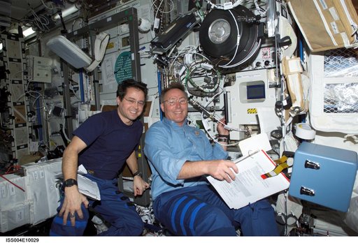 Bursch and Ross by EXPRESS rack 4 in the U.S. Lab during STS-110, Expedition Four joint OPS