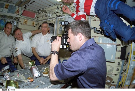 STS-110 crewmembers pose for photos in the Zvezda SM during Expedition Four