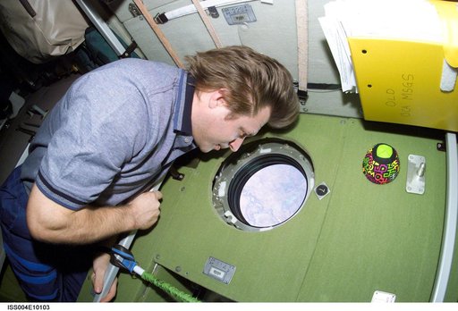 Onyfrienko looks through a window in the Zvezda SM during Expedition Four