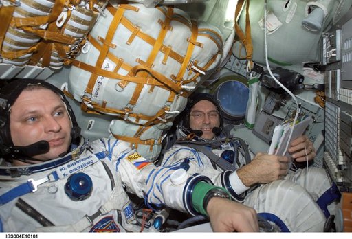 Onufrienko and Walz seated in the Soyuz 3 capsule during Expedition Four rescue craft relocation