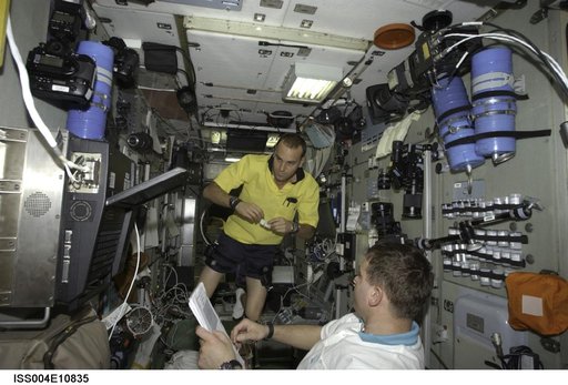 Soyuz 4 CDR Gidzenko reads a checklist in Zvezda SM during Expedition Four
