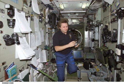 Onufrienko holds a Grab Sample Container (GSC) in the SM during Expedition Four