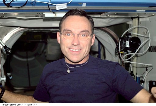 Carl Walz smiles for the camera in the U.S. Laboratory during Expedition Four
