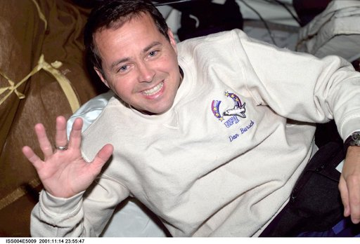 Dan Bursch smiles and waves for the camera from the middeck during Expedition Four