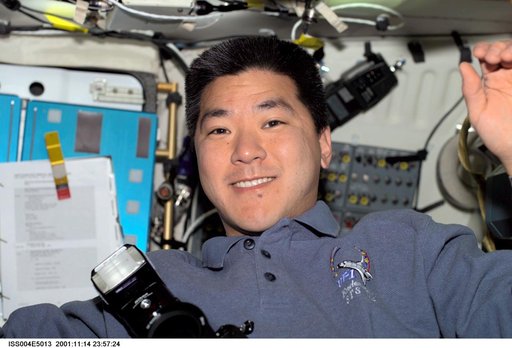 Dan Tani smiles for the camera from Endeavour's middeck during STS-108, Expedition Four