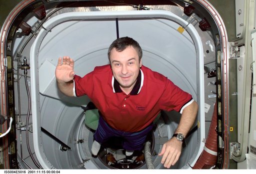 Vladimir Dezhurov smiles for the camera from PMA 2 during Expedition Three / Four
