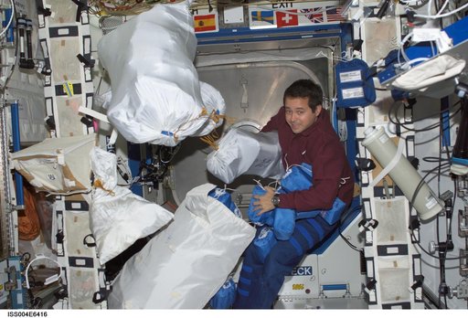 Bursch works with stowage bags in the U.S. Laboratory during Expedition Four