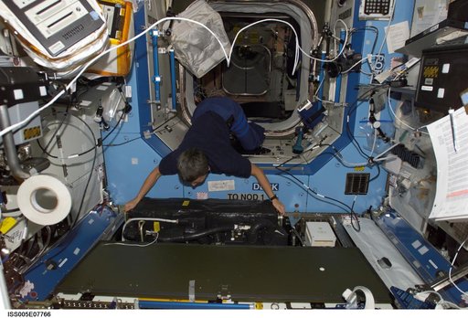 Whitson moves equipment in the U.S. Laboratory during Expedition Five on the ISS