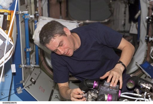 Korzun working on TCS in the U.S. Laboratory during Expedition Five on the ISS