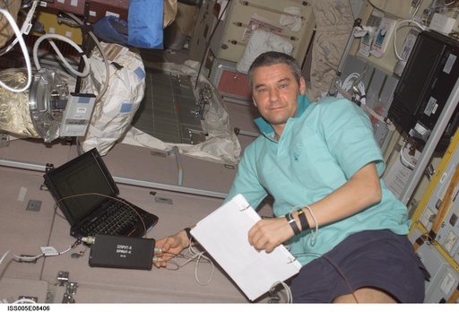 Korzun working on laptop computer in the SM taken during Expedition Five on the ISS