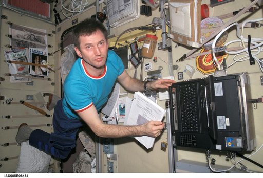 Treschev works on laptop computer in the SM taken during Expedition Five on the ISS