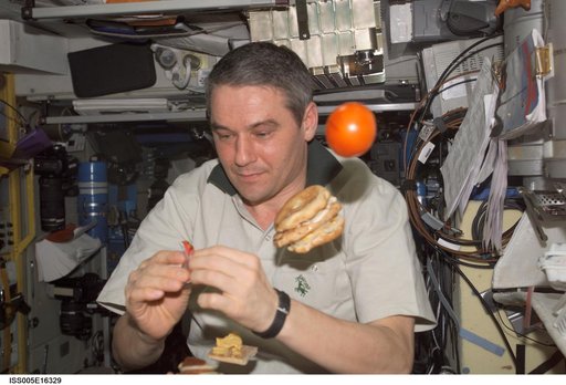 Korzun eating in the SM during Expedition Five on the ISS