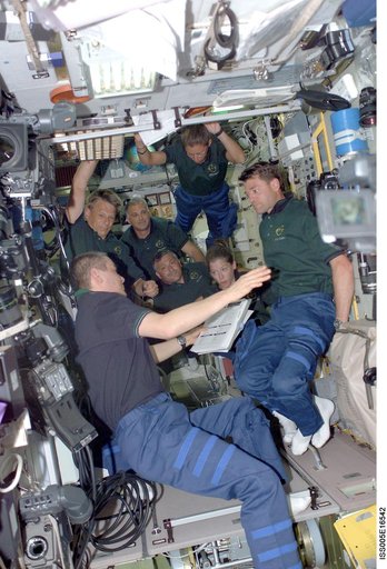 Korzun and STS-112 crewmembers in the SM during Expedition Five on the ISS