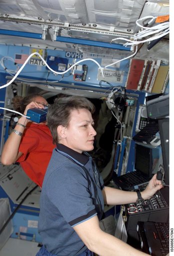 Whitson and Magnus working in the U.S. Laboratory during Expedition Five on the ISS