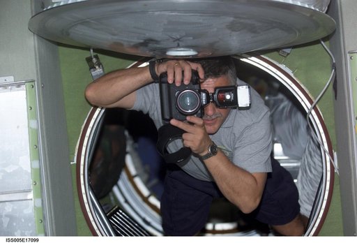 Yurchikhin uses a still photo camera while floating in the SM during Expedition Five on the ISS