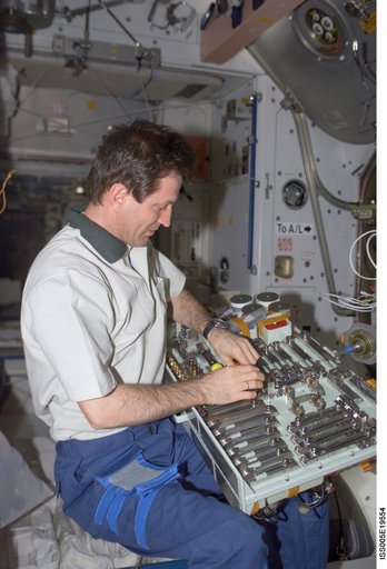 Treschev holds a pallet of tools in the Node 1 during Expedition Five on the ISS