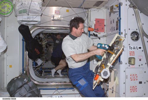 Treschev holds a pallet of tools in the Node 1 during Expedition Five on the ISS